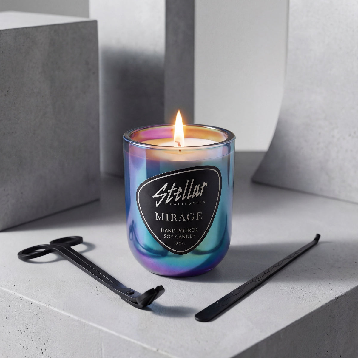 Iridescent candle with 'Stellar Mirage' label on a gray surface