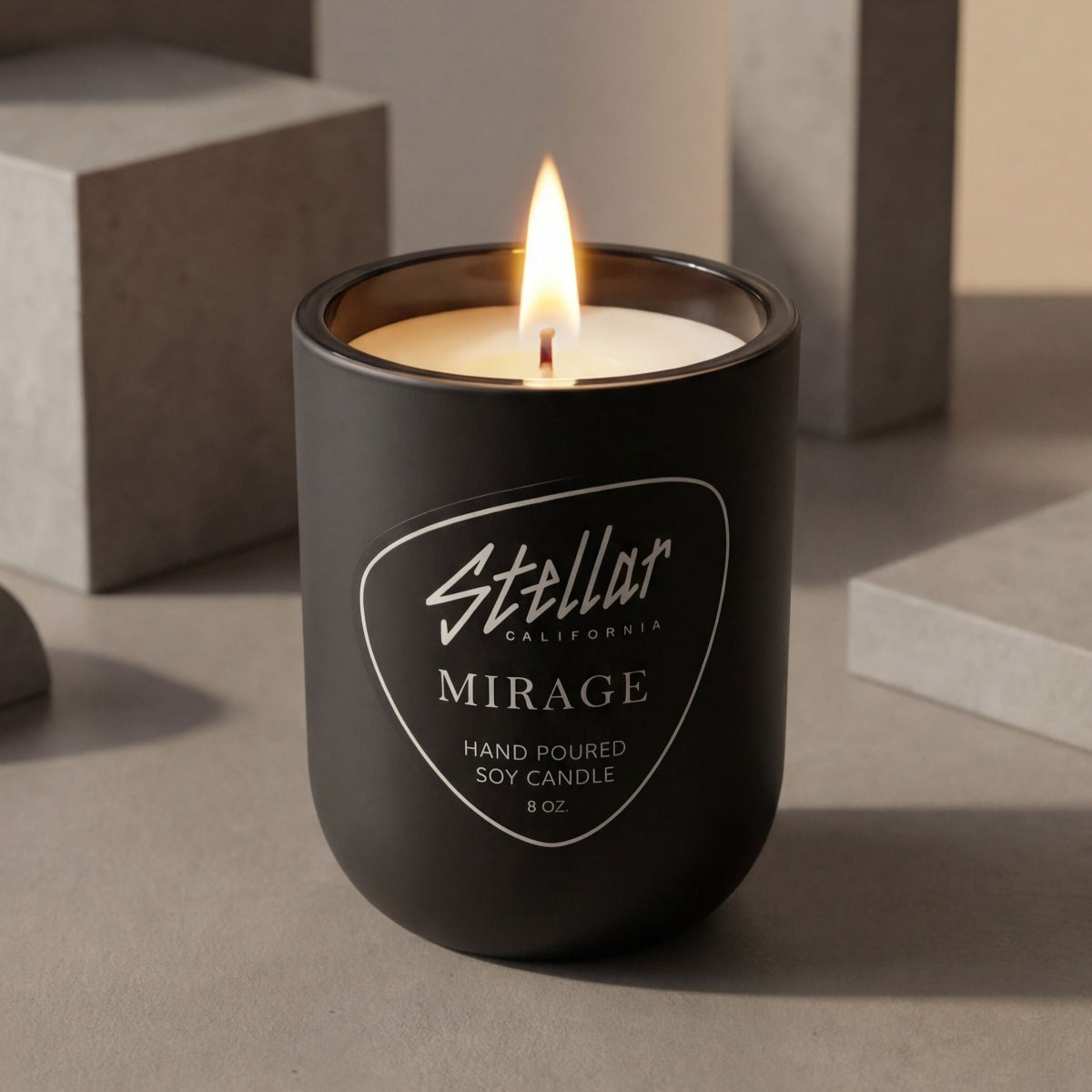 “Luxury warm candle in matte black glass vessel.”