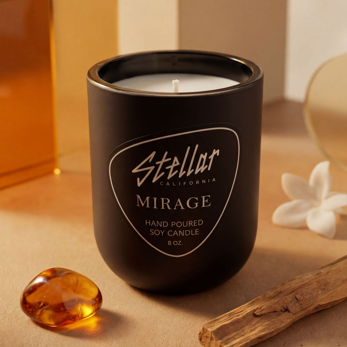 “Mirage matte black candle with warm jasmine and amber scent.”