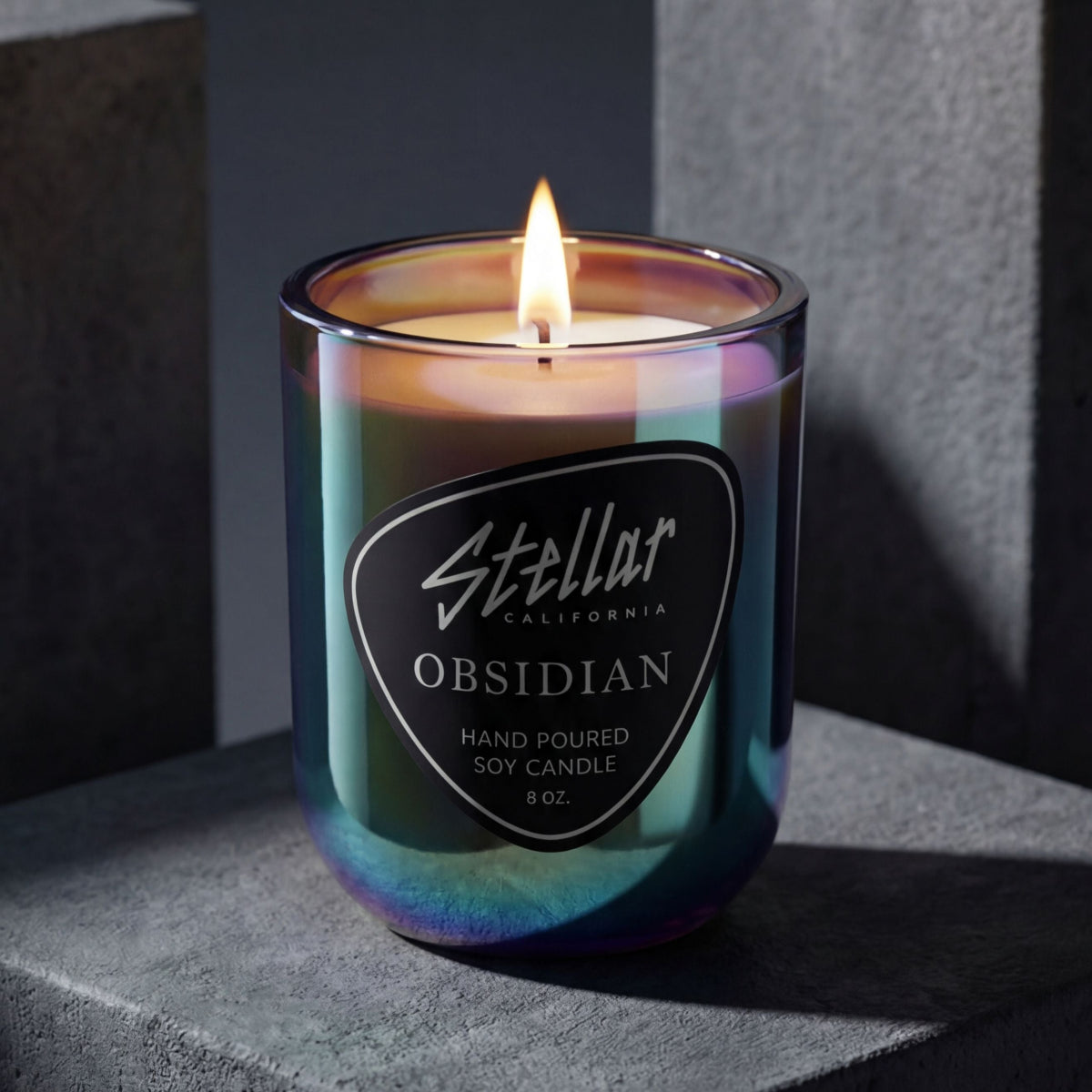 “Obsidian chromatic candle with shifting metallic colors and coastal fragrance.”