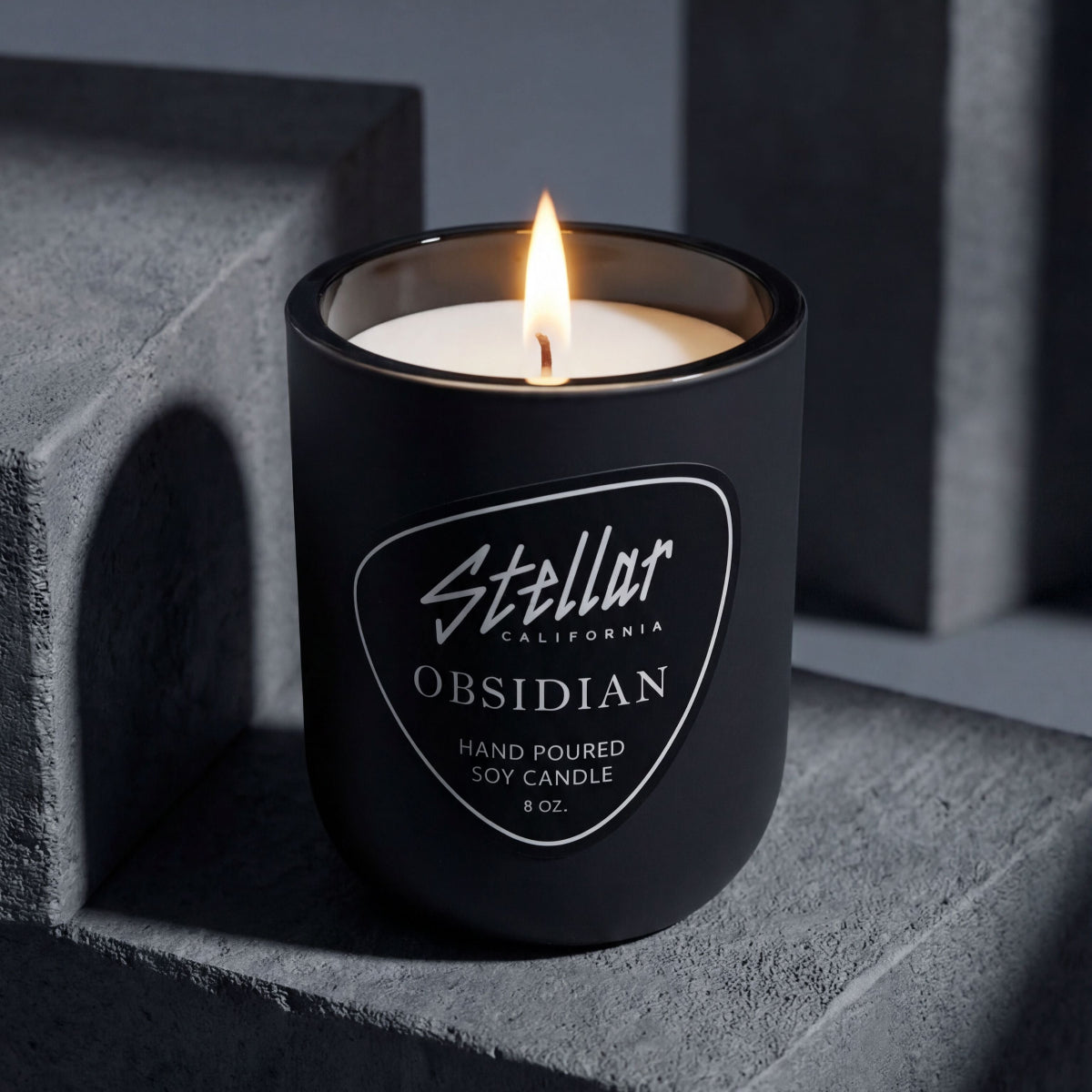 “Obsidian matte black candle with coastal-inspired scent and velvety finish.”