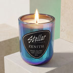 “Luxury botanical candle in color-shifting glass.”